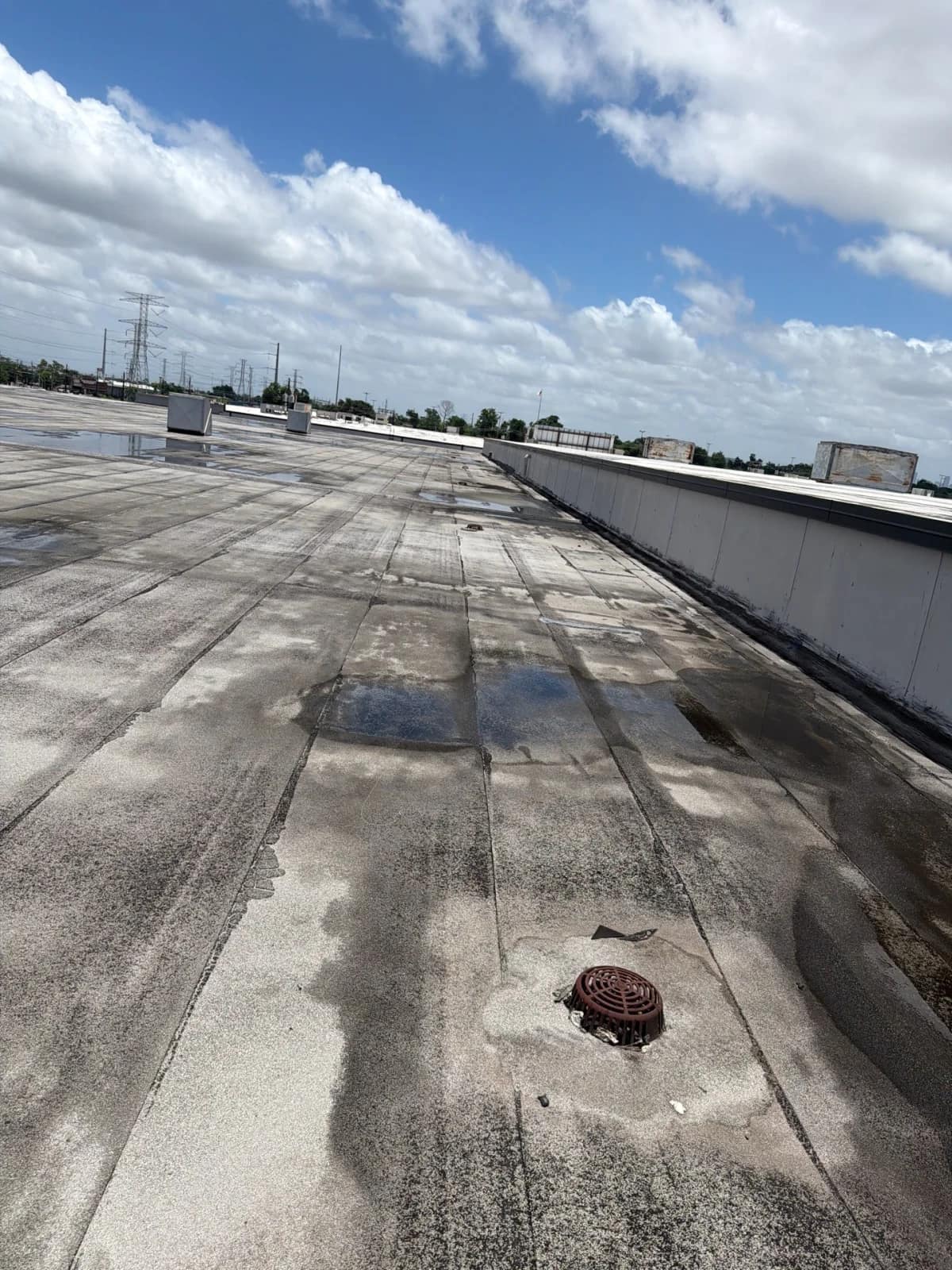 Commercial built-up flat roof in Houston, Texas serviced by Elevation Roofing & Restoration — a low-slope BUR system with roof drain and parapet wall