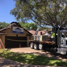 Roofing crew installing new asphalt shingles during a professional roof installation on a Texas home