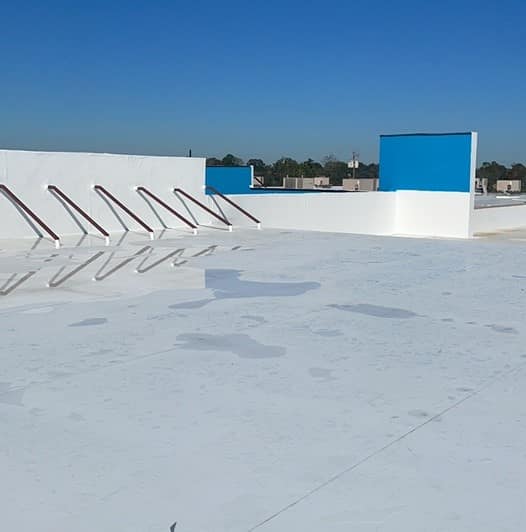 Standing seam metal roof on a Texas home under bright summer sun, the focus of metal roof summer maintenance